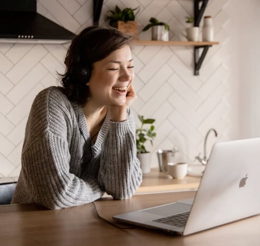 woman in videocall, she's weaaring headphones and she's smiling